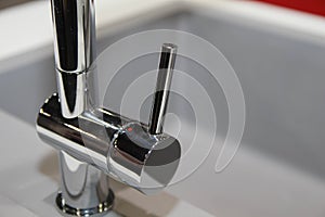 Monochrome kitchen detail. Close up of modern kitchen faucet and sink