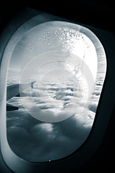 A monochrome look outside the window of a plane.