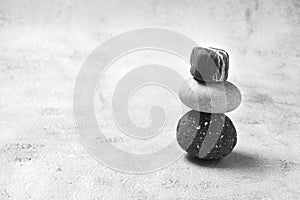 Monochrome minimalism. A stack of stones on light gray background . Space for text