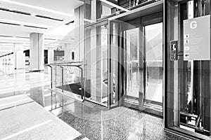 monochrome Modern steel elevator doors cabins in a business lobby or Hotel, Store, interior, office,perspective wide angle. Three