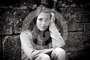 Monochrome outdoor portrait of a sad teenage girl