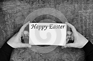 Monochrome photo male hands holding a white sheet of paper happy