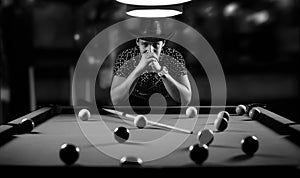 Monochrome photo young man playing billiards