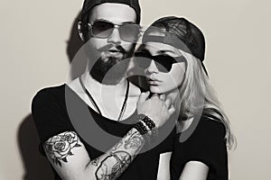 Monochrome portrait of beautiful couple together. Tattoo Hipster boy and gir