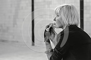 Monochrome portrait of beautiful woman in the empty swimming pool