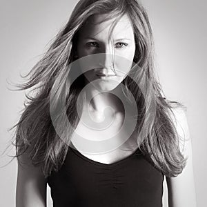 Monochrome portrait of a beautiful young woman wearing a black shirt