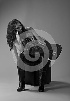 Monochrome portrait of rocker girl with guitar