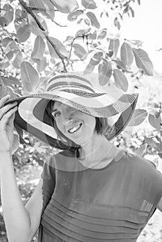 Monochrome portrait of a woman in a wide brimmed sunhat looking