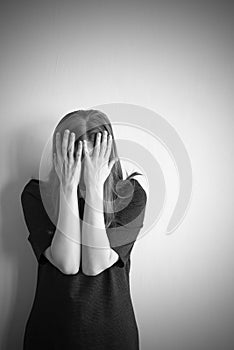 Monochrome portrait of young beautiful woman in depression
