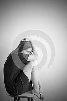 Monochrome portrait of young beautiful woman in depression