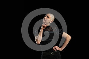 Monochrome portrait of young caucasian bald woman on black background