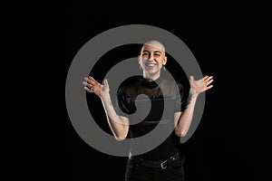 Monochrome portrait of young caucasian bald woman on black background