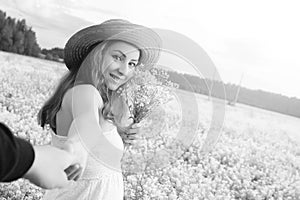 monochrome portrait of young girl in a hat standing in a huge fi