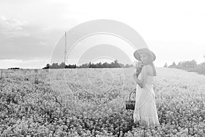 monochrome portrait of young girl in a hat standing in a huge fi