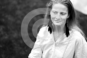 Monochrome portrait of young natural woman on nature background