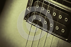 Monochrome retro image of a guitar pickup