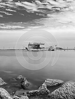 monochrome/ rocks ,sea and fishing boat