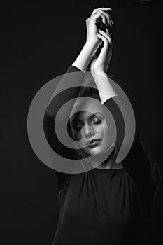 Monochrome studio portrait of a worried woman