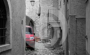 monocolor red car in black and white street