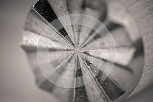 Monocrome macro shot of a wooden meat tenderizer, metal end