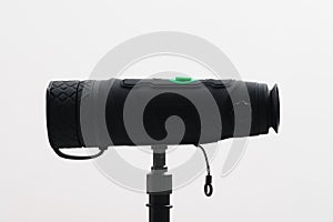 Monocular on a tripod isolated on a white field.