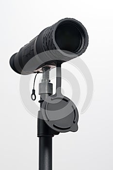 Monocular on a tripod isolated on a white field.