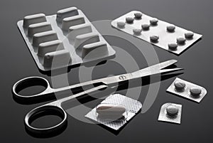 Monodose medication pills with scissors, conceptual image