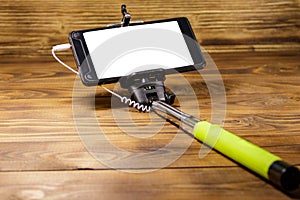 Monopod for selfie with smart phone on wood desk