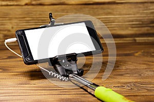 Monopod for selfie with smart phone on wood desk