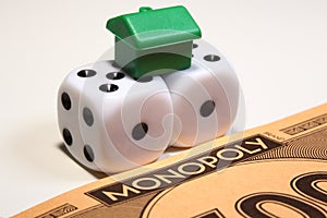 Monopoly money, dice and house