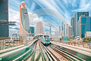 Monorail Subway train rides among glass skyscrapers in Dubai. Traffic on street in Dubai. Cityscape skyline. Urban