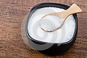 Monosodium glutamate in black bowl with spoon