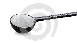 Monosodium glutamate in spoon on white background