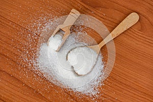 Monosodium glutamate on spoon and wooden table background, MSG for food seasoning