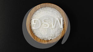 Monosodium glutamate, White crystalline granules in wooden bowl with symbol MSG, Rotating. Food additive E621