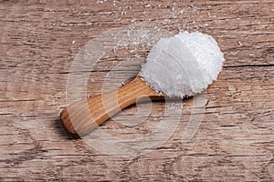 monosodium glutamate in a wooden spoon