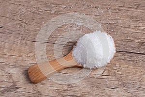 monosodium glutamate in a wooden spoon