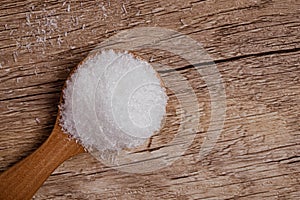 monosodium glutamate in a wooden spoon