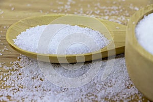 Monosodium glutamate on wooden table.
