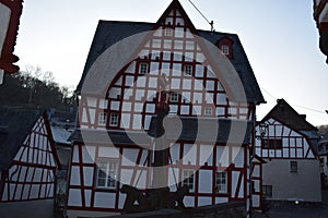 Monreal, Germany - 12 12 2022: Medieval bridge with the lions in front of a half-timbered house, evening mood