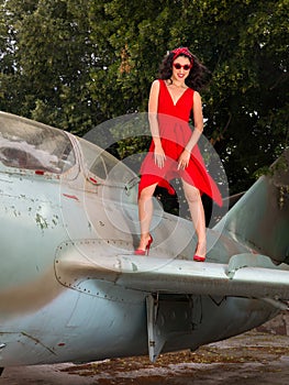 Monroe pose on the wing of a vintage airplane