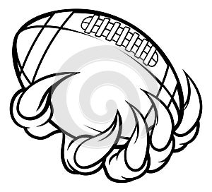 Monster animal claw holding American Football Ball