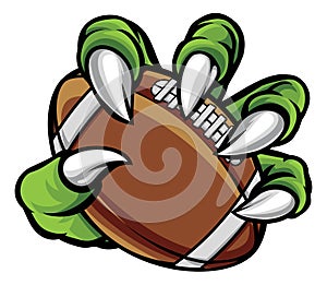 Monster animal claw holding American Football Ball