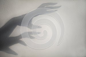 Monster claw shadow on wall. Horror hand shadow on a white background, copy space.