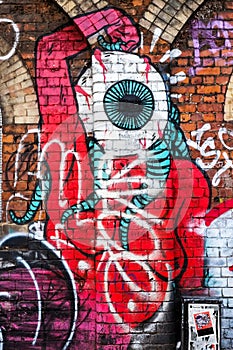 Monster creature with big eye, graffiti wall art, London UK