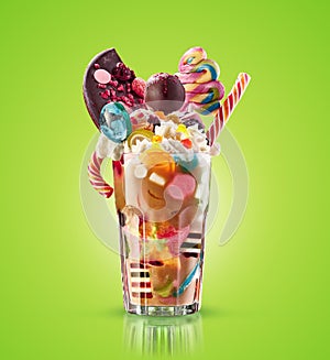 Monster shake, freak caramel shake . Colourful, festive milk shake cocktail with sweets, jelly. Colored caramel