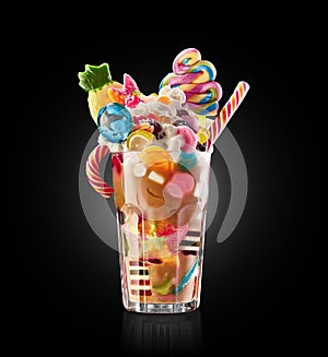 Monster shake, freak caramel shake isolated. Colourful, festive milk shake cocktail with sweets, jelly. Colored caramel