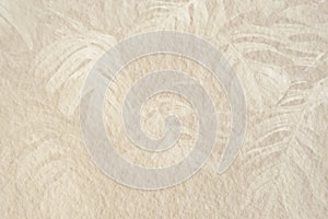 Monstera leaf pattern on a beige cement background illustration photo