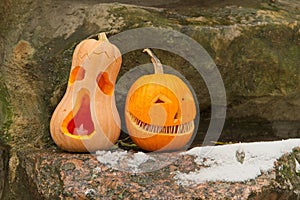 Monsters carved from pumpkins on a stone wall, Halloween.