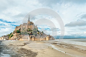 Mont Saint Michel abbey on the island during low tide, Normandy, Northern France, Europe. Tidal island with medieval